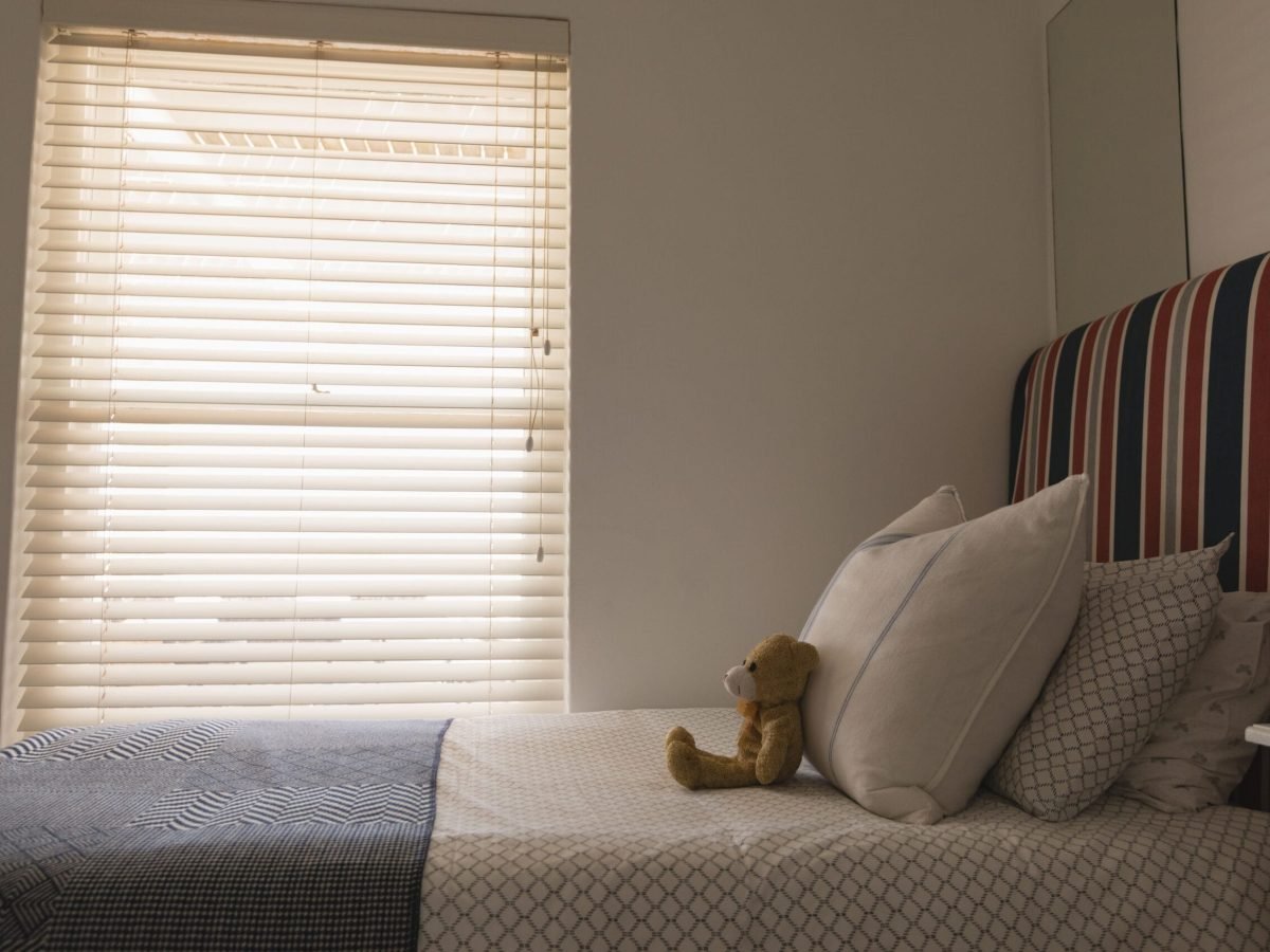 side-view-of-teddy-bear-on-a-bed-in-bedroom-at-hom-2023-11-27-04-57-16-utc